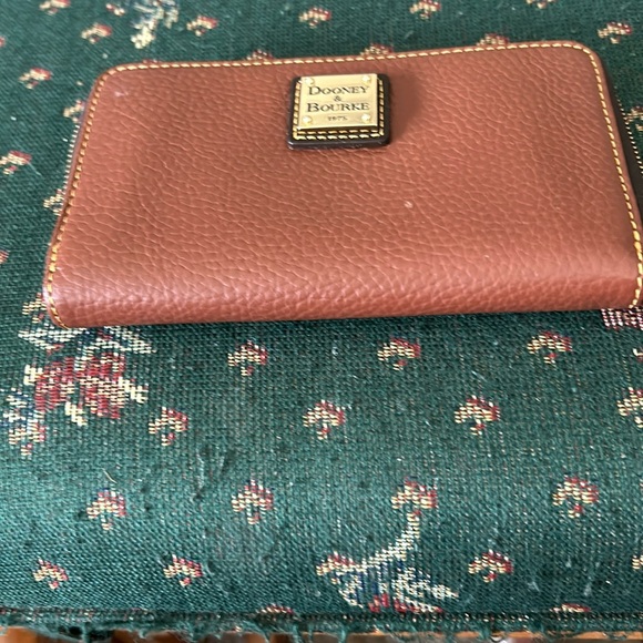 Dooney & Bourke Handbags - Dooney and Bourke brown wristlet 7” by 4” in leather with red lining